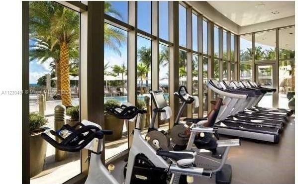 gym featuring a wall of windows and a wealth of natural light