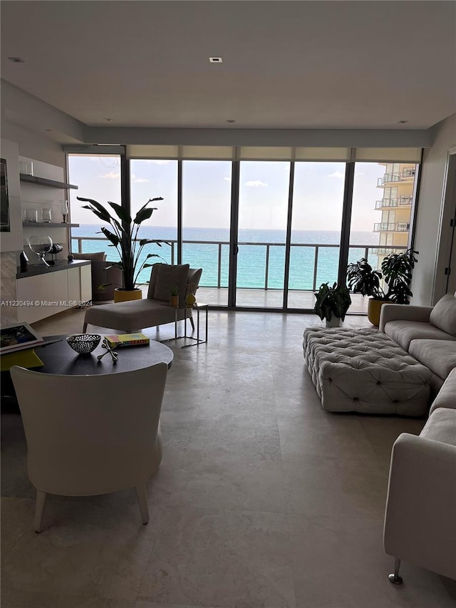 living room featuring expansive windows and a water view