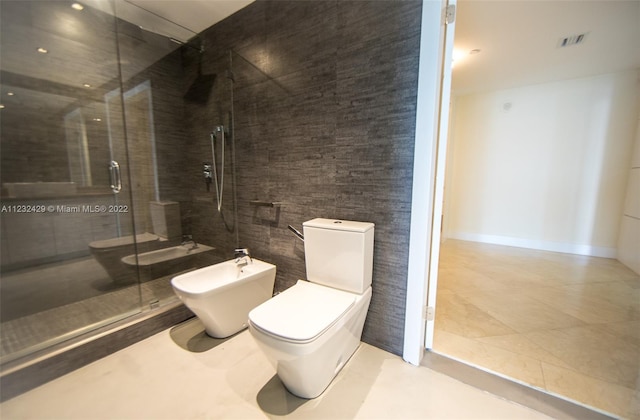 bathroom with an enclosed shower, tile walls, tile floors, toilet, and a bidet