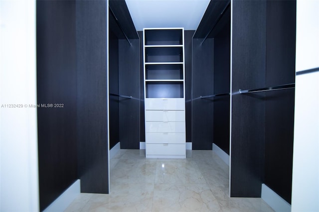 spacious closet featuring light tile floors