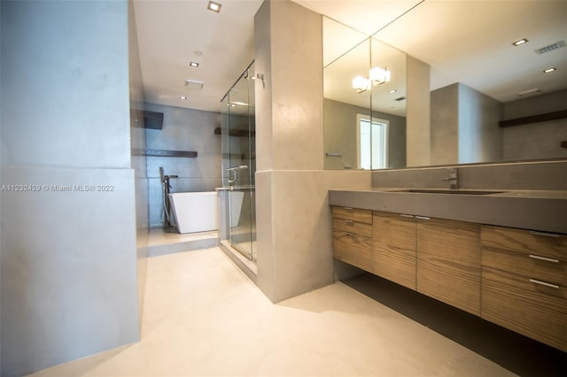 bathroom featuring plus walk in shower, a notable chandelier, and vanity