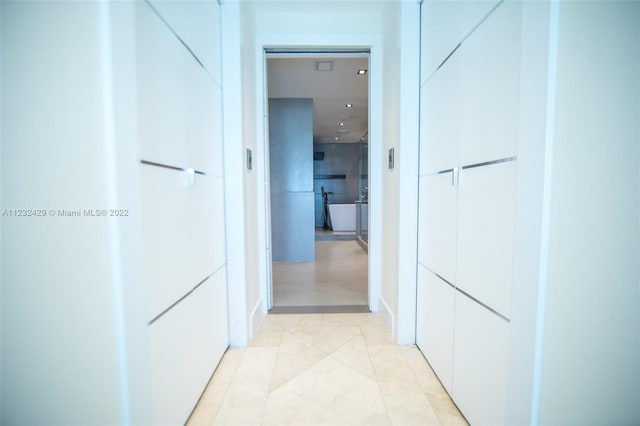 hallway featuring light tile floors