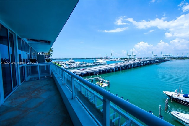 balcony featuring a water view and a boat dock