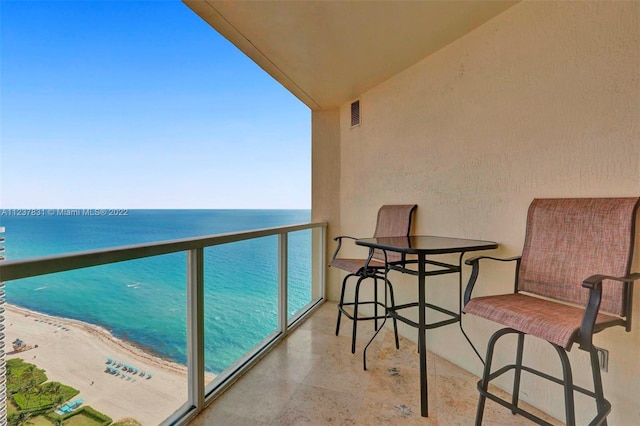 balcony with a view of the beach and a water view