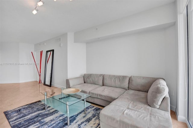 living room featuring track lighting and light tile flooring