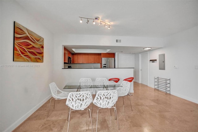 dining room with light tile floors and track lighting