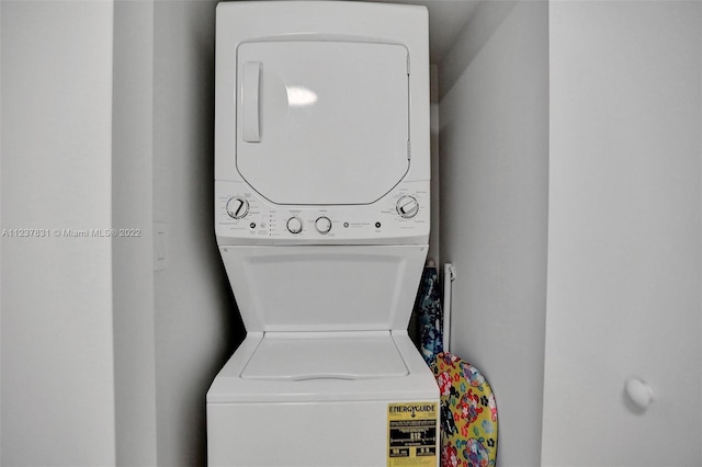 clothes washing area featuring stacked washer / drying machine