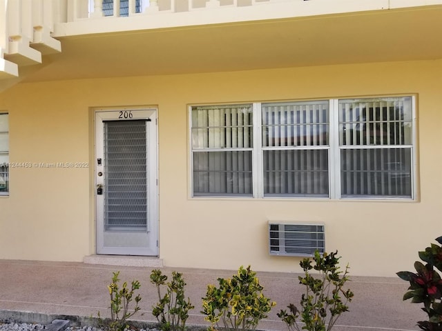 entrance to property featuring a wall unit AC