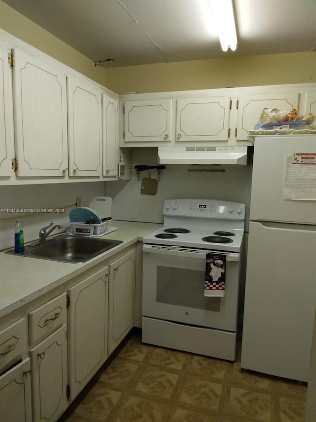 kitchen featuring light parquet flooring, white cabinetry, white appliances, and sink