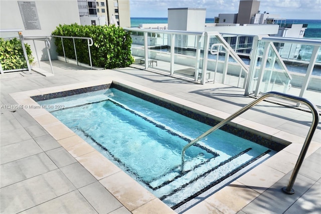 view of swimming pool with a water view