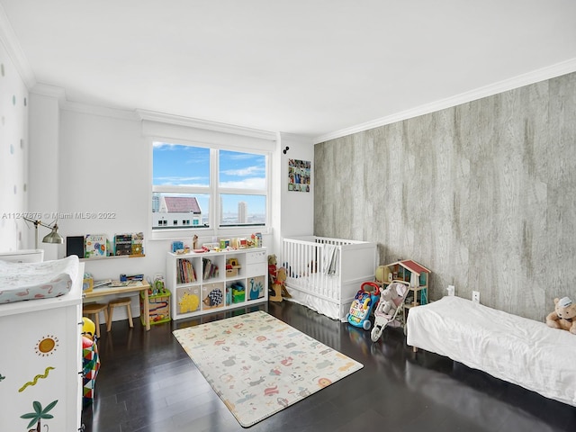 bedroom with ornamental molding and dark wood-type flooring