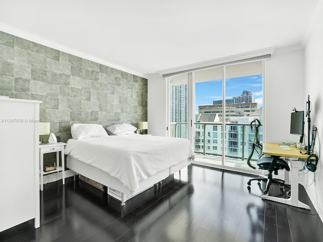 bedroom with tile walls, ornamental molding, expansive windows, access to outside, and dark wood-type flooring