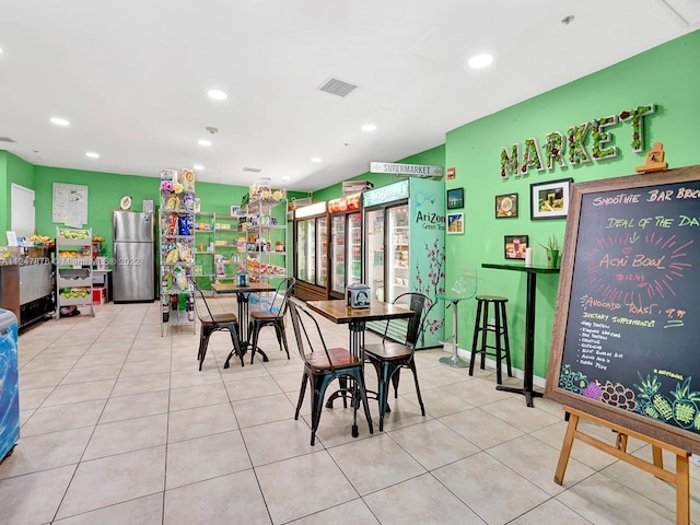 dining space with light tile flooring