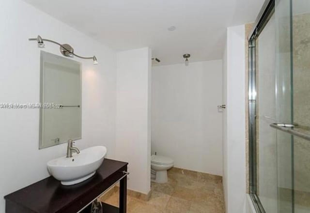 bathroom with vanity, tile floors, and toilet