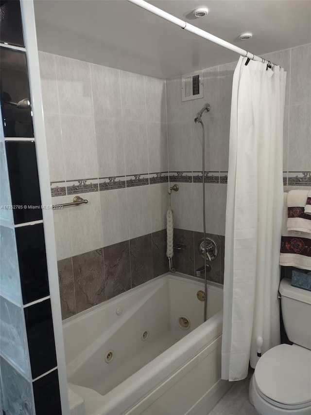 bathroom with toilet and shower / bath combo