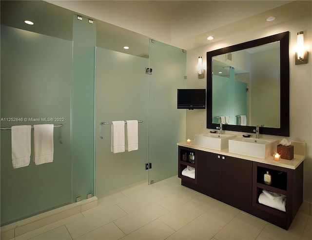 bathroom with double vanity, tile floors, and walk in shower