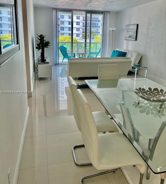 dining area with plenty of natural light and light tile floors