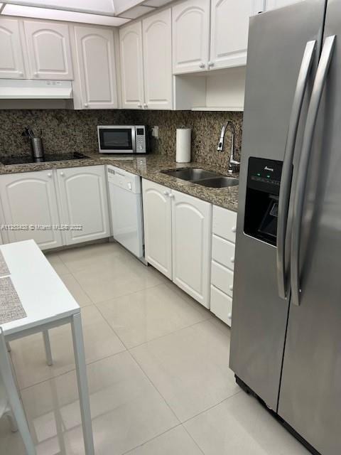 kitchen featuring appliances with stainless steel finishes, sink, white cabinets, ventilation hood, and tasteful backsplash