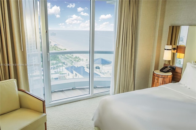 tiled bedroom featuring a water view and access to outside