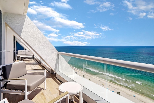 balcony with a beach view and a water view