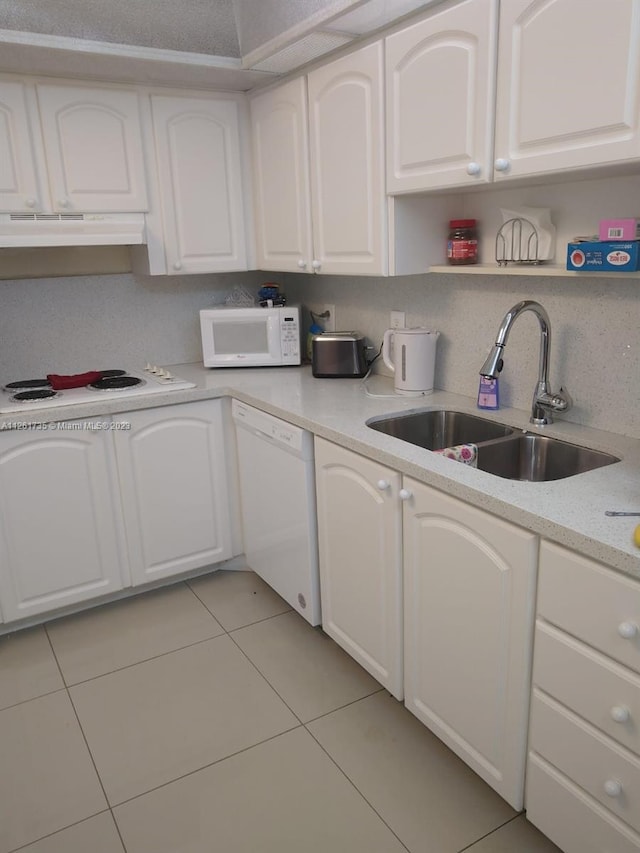 kitchen with white appliances, white cabinets, sink, and light tile floors