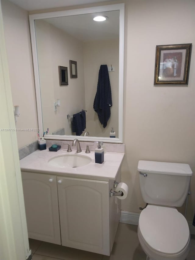 bathroom featuring oversized vanity, toilet, and tile floors