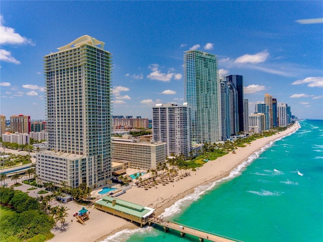 property's view of city with a view of the beach and a water view