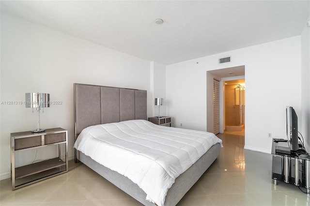 tiled bedroom with ensuite bath