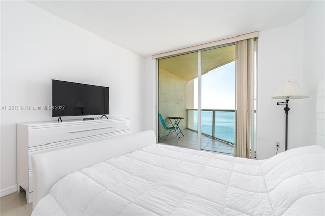 bedroom featuring access to exterior and floor to ceiling windows