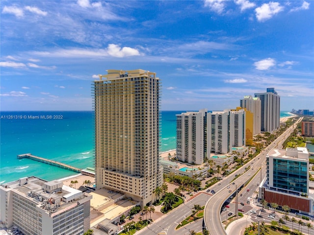 birds eye view of property with a water view and a view of the beach