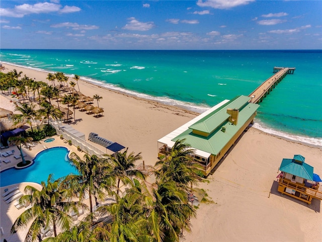 birds eye view of property featuring a water view and a beach view