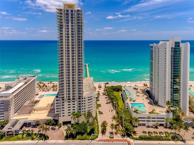 birds eye view of property with a view of the beach and a water view