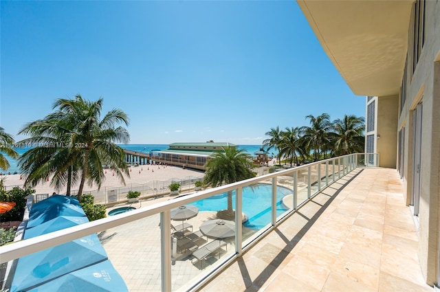 view of swimming pool with a water view