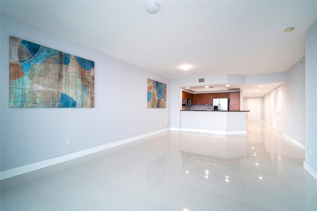 unfurnished living room featuring light tile floors