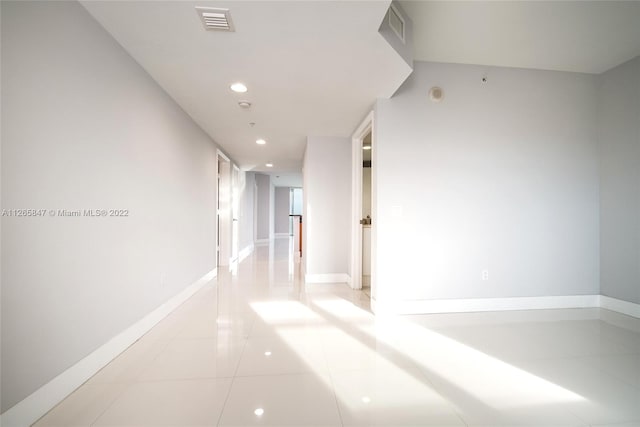 hall featuring light tile floors