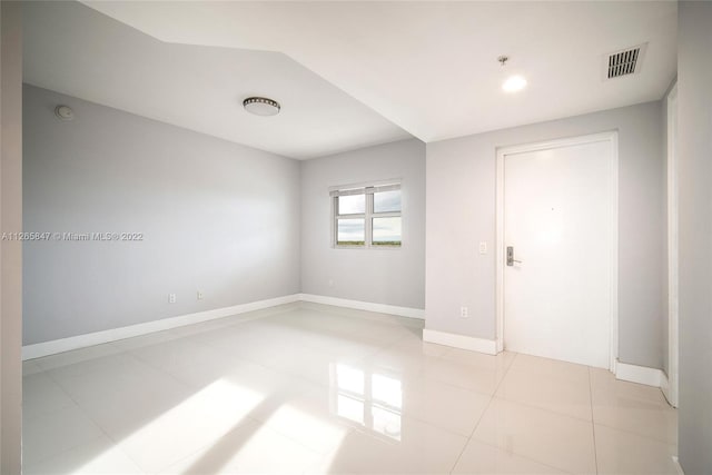 spare room with light tile flooring