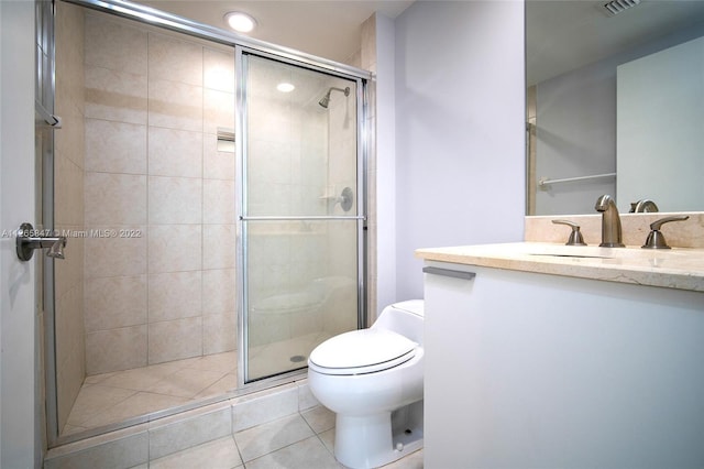 bathroom with toilet, tile flooring, a shower with shower door, and vanity