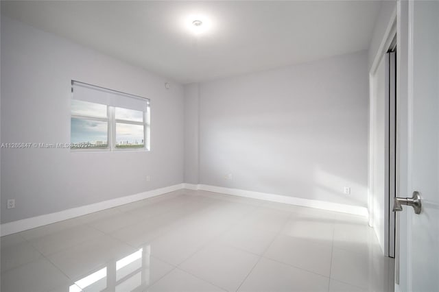 unfurnished room featuring light tile flooring