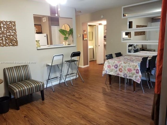 dining space with ceiling fan and dark wood-type flooring