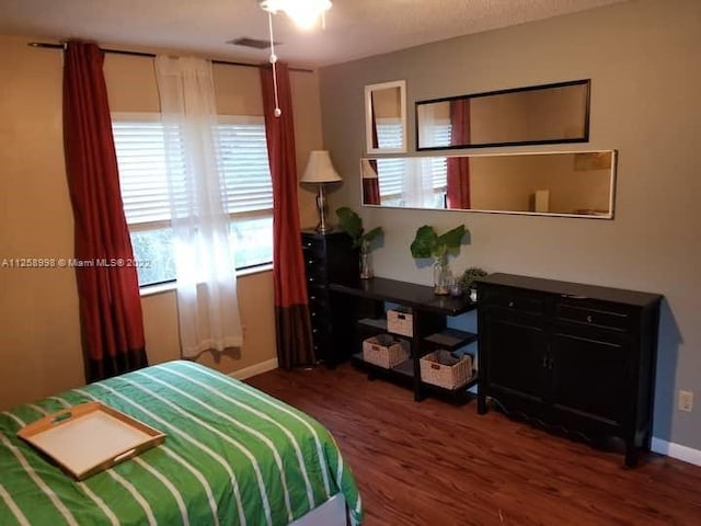 bedroom featuring dark hardwood / wood-style flooring