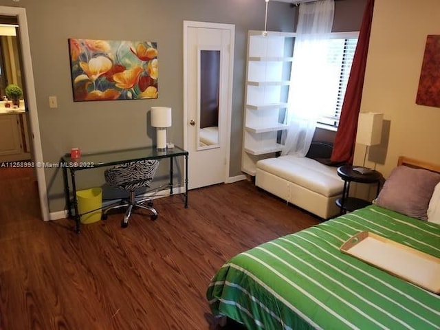 bedroom with dark hardwood / wood-style flooring