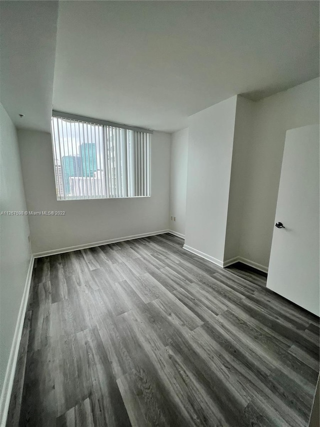 spare room featuring dark hardwood / wood-style flooring