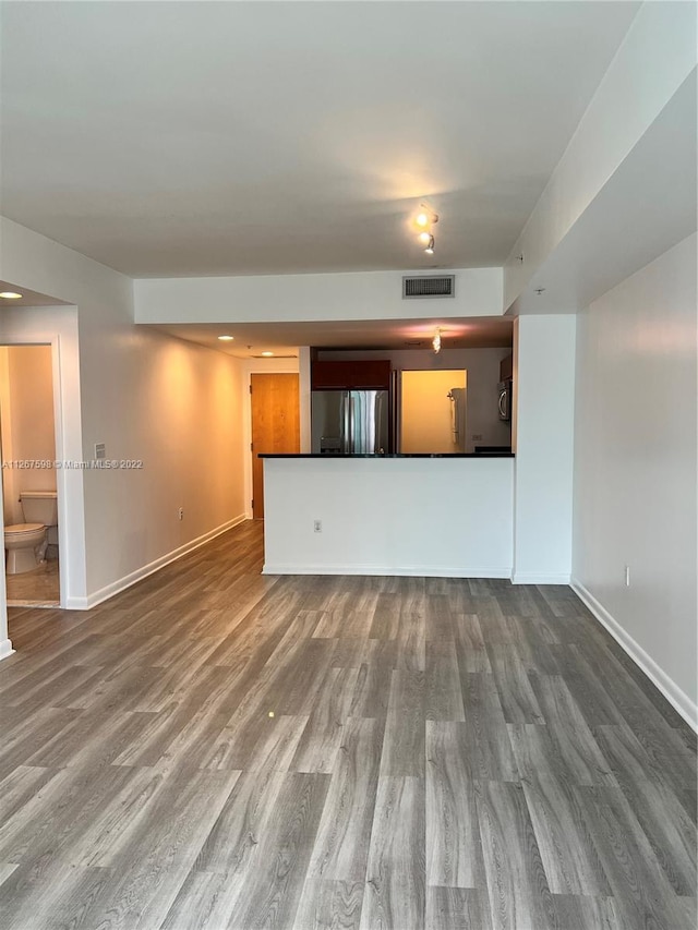 unfurnished living room featuring hardwood / wood-style flooring