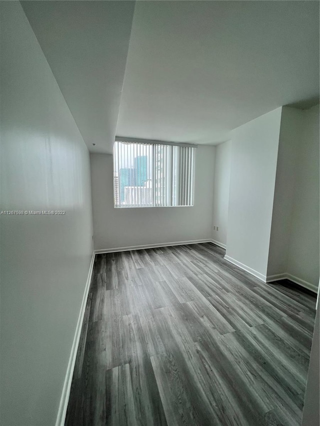 spare room with dark hardwood / wood-style floors