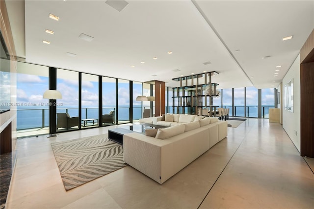 living room with a water view and a wall of windows