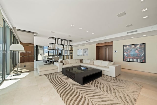 living room featuring a wall of windows and light tile floors