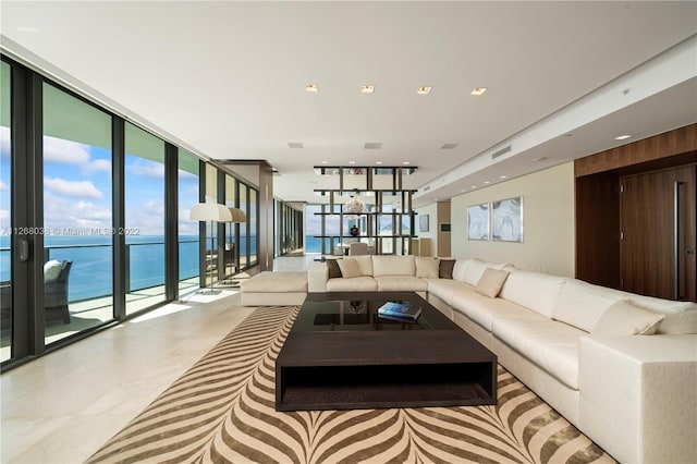 interior space featuring a water view, floor to ceiling windows, light tile floors, and french doors