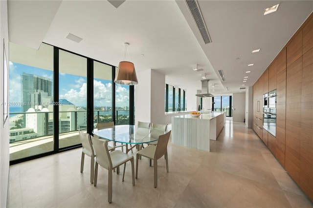 tiled dining room with wood walls and expansive windows