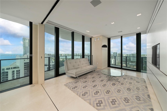 living room with floor to ceiling windows and french doors