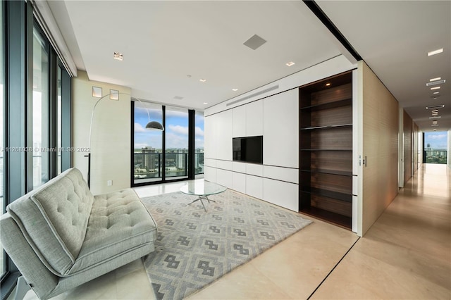 living room featuring a healthy amount of sunlight and expansive windows